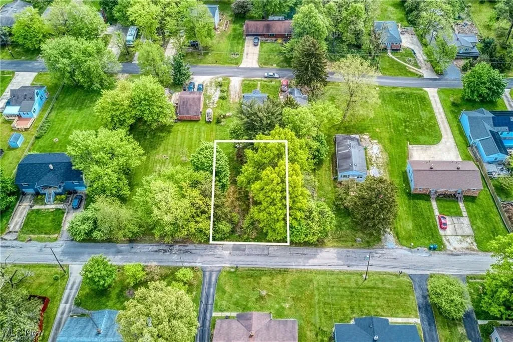Aerial view of residential area with property boundaries highlighted