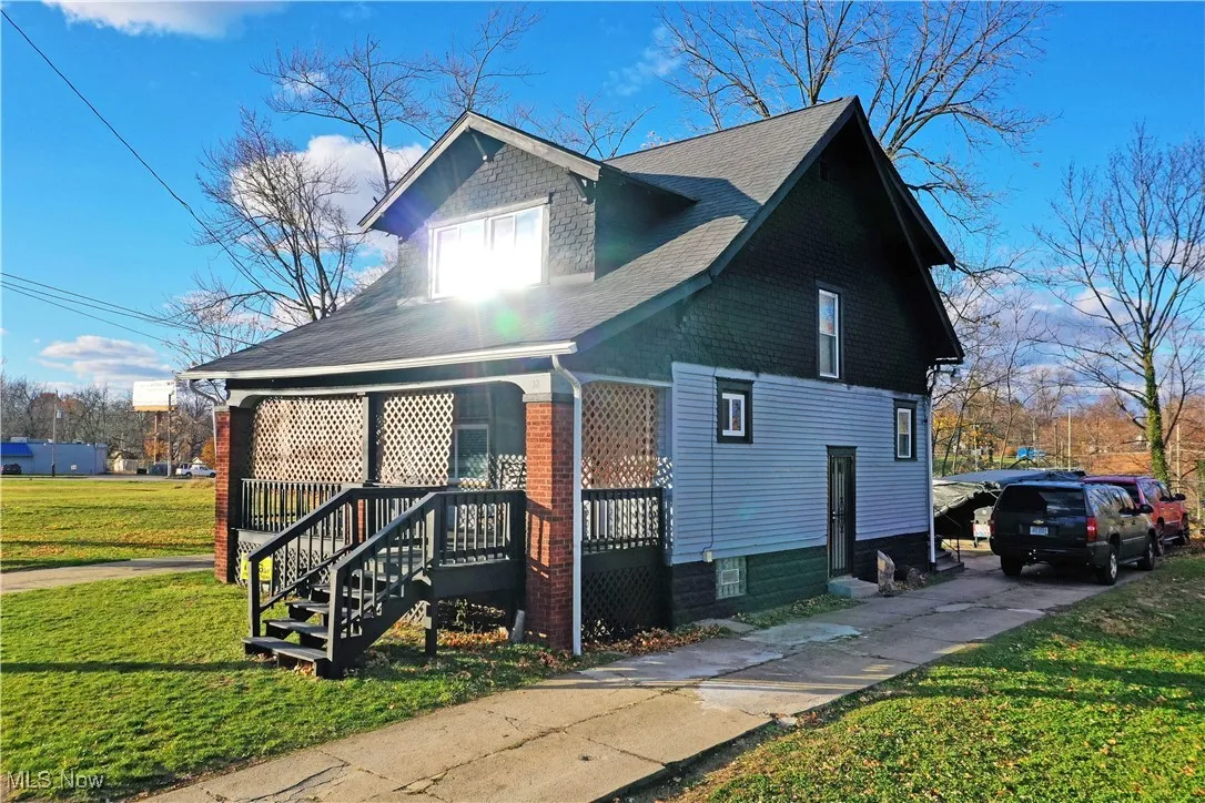 View of home's exterior featuring a yard, a shingled roof, and concrete driveway
