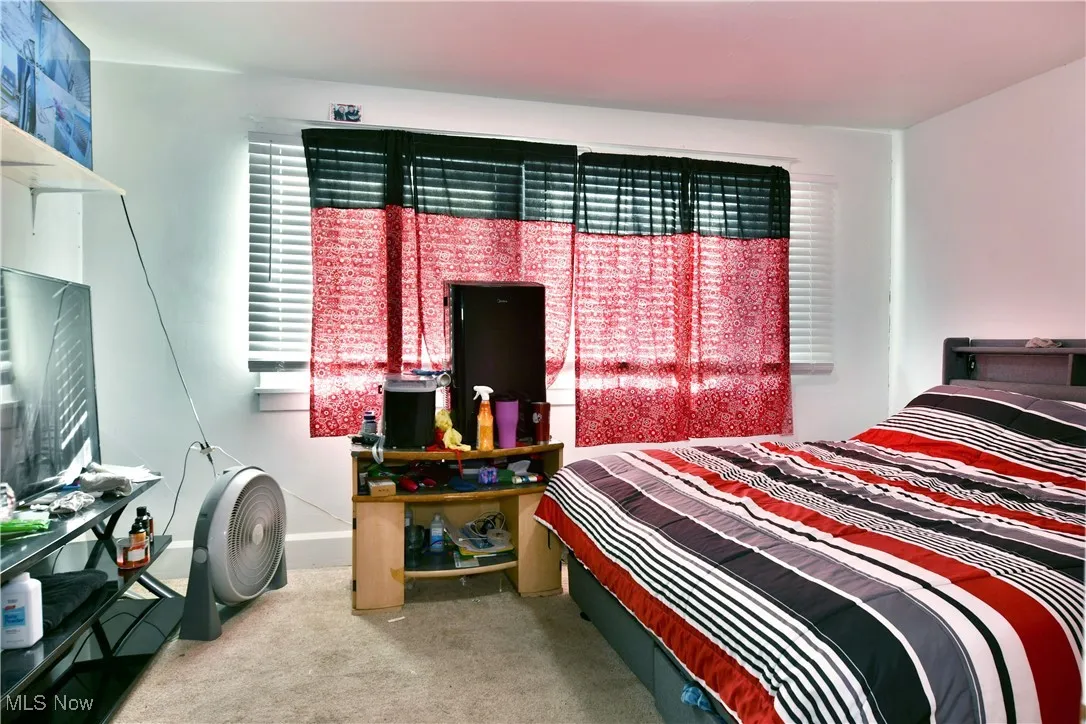 Carpeted bedroom featuring baseboards