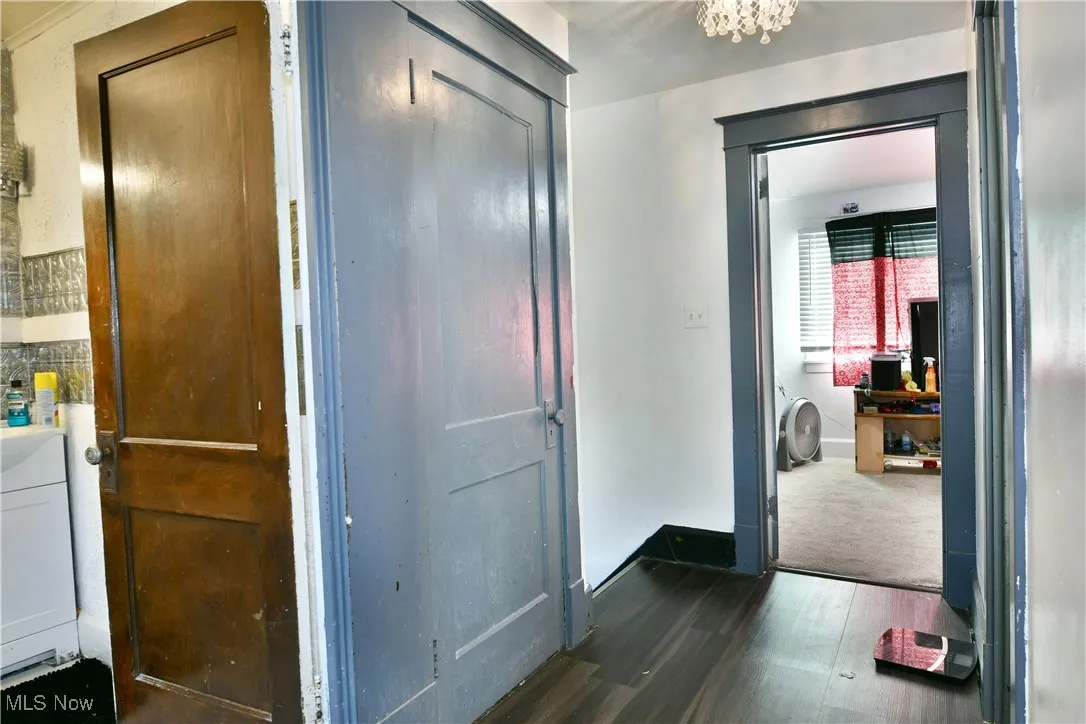 Hall with dark wood finished floors and baseboards