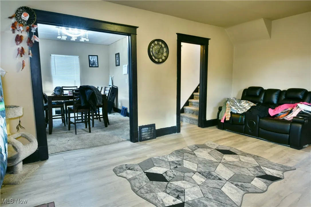 Living area featuring light wood-style flooring and stairs