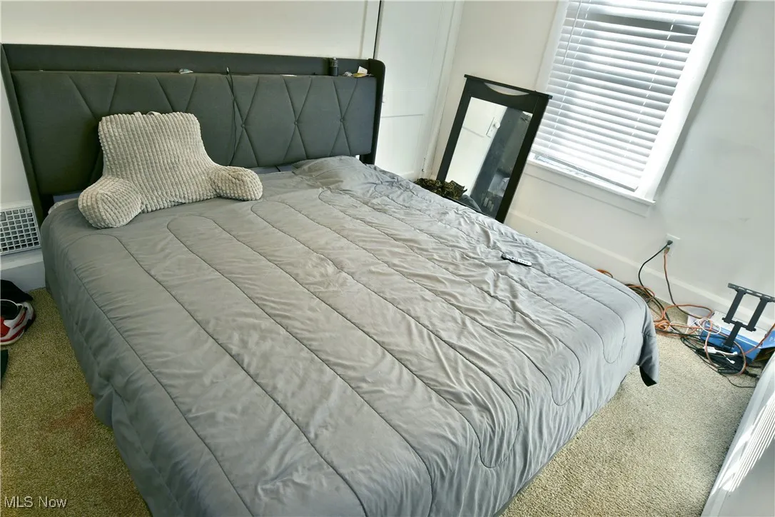Carpeted bedroom with baseboards