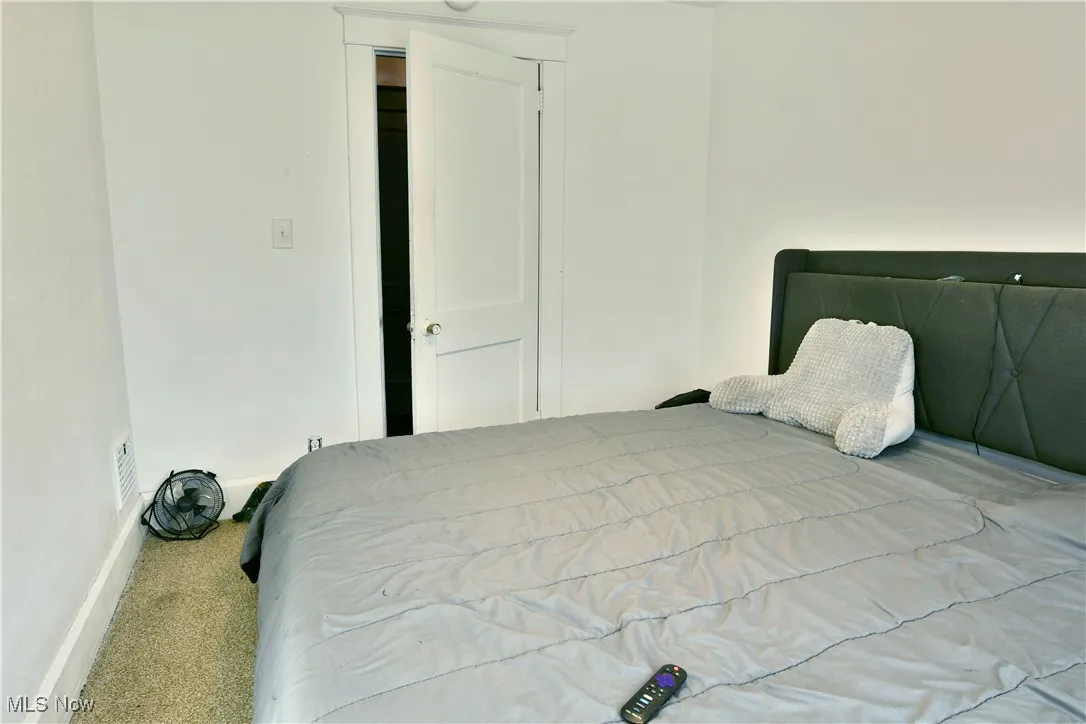 Carpeted bedroom featuring baseboards