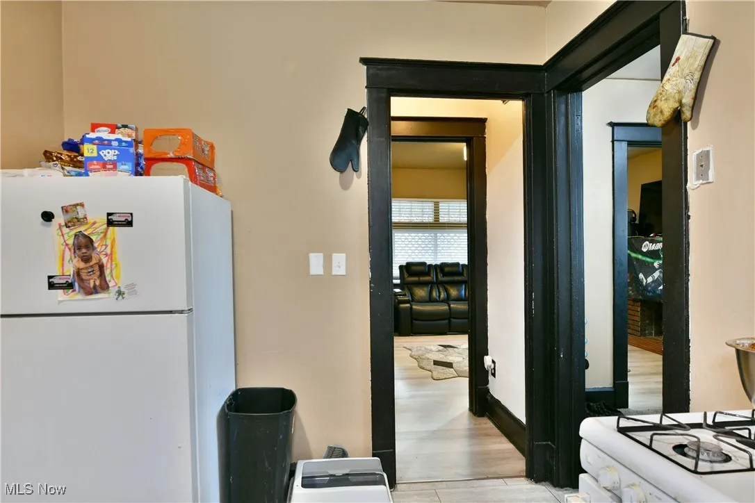 Kitchen featuring freestanding refrigerator and light wood finished floors