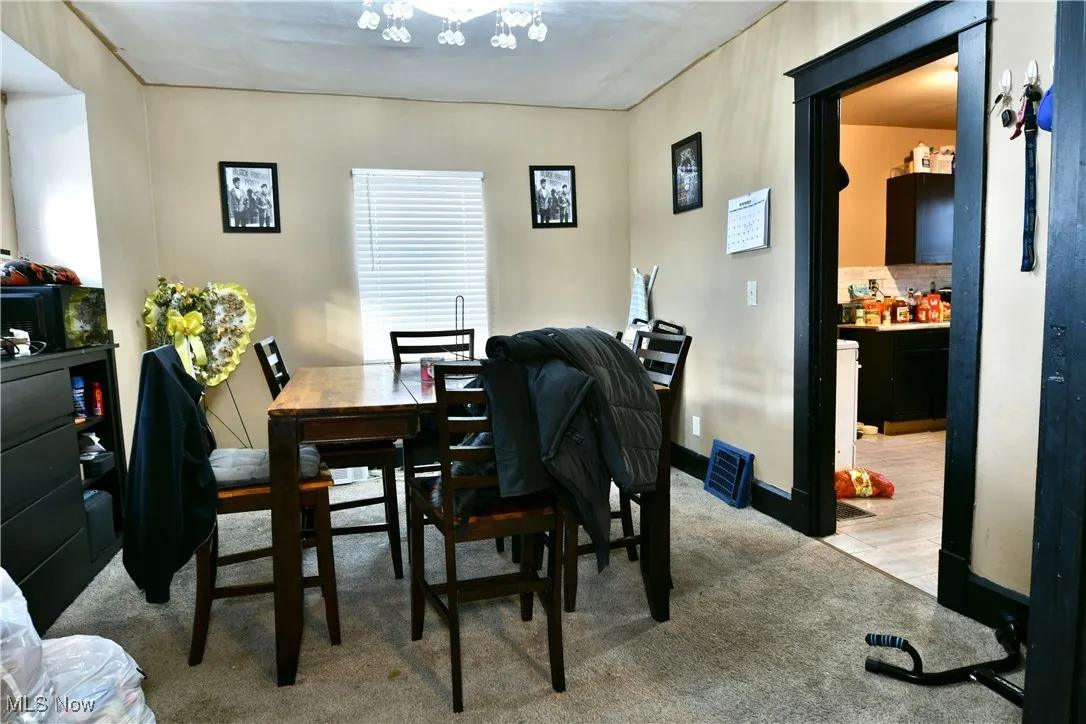 Dining room with light colored carpet and baseboards