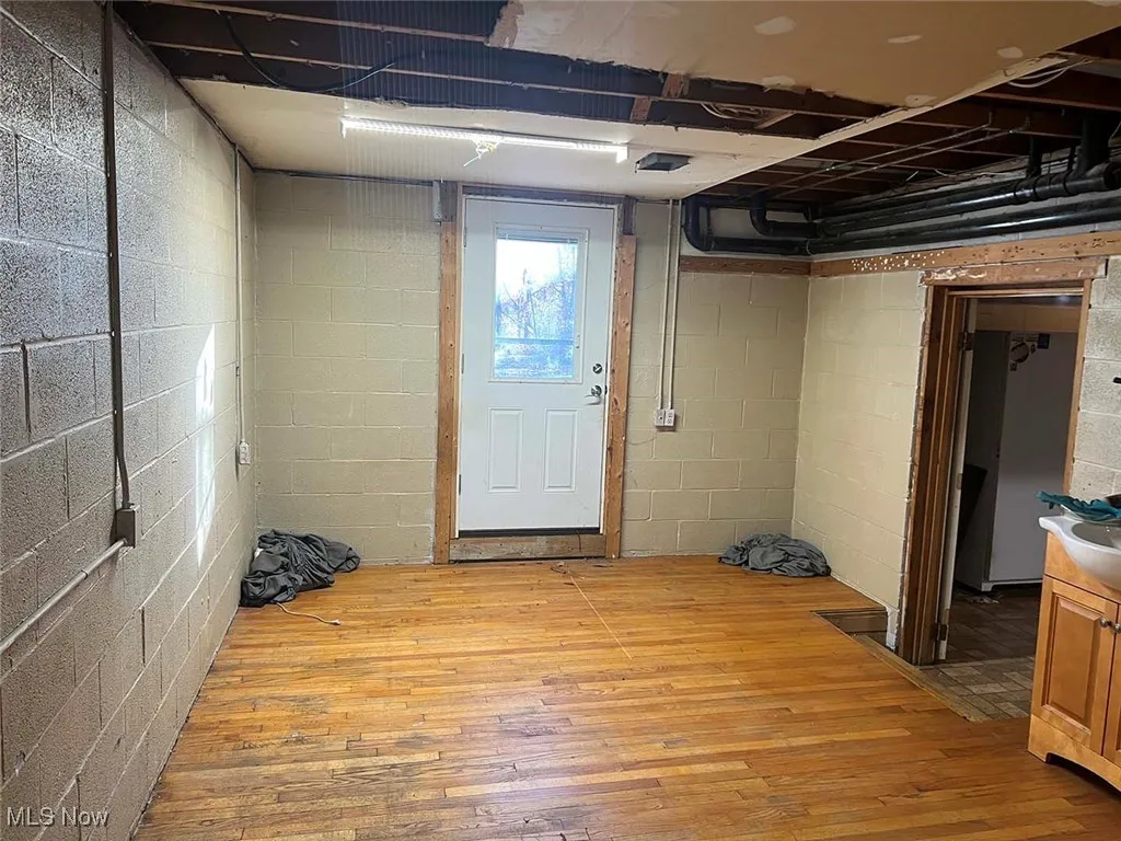 Below grade area with light wood-type flooring