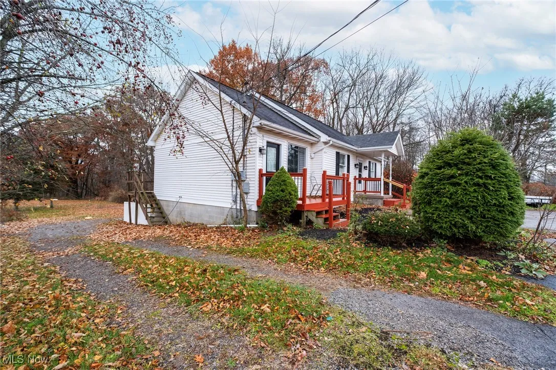 View of side of home featuring a deck