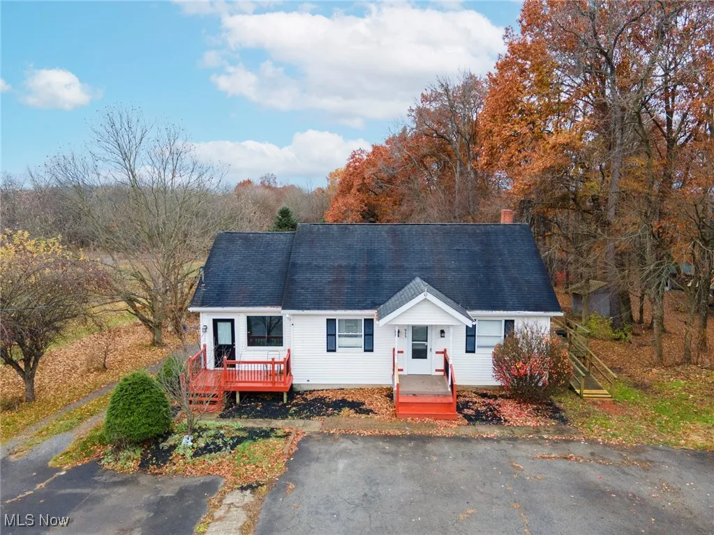 Cape cod house featuring a chimney