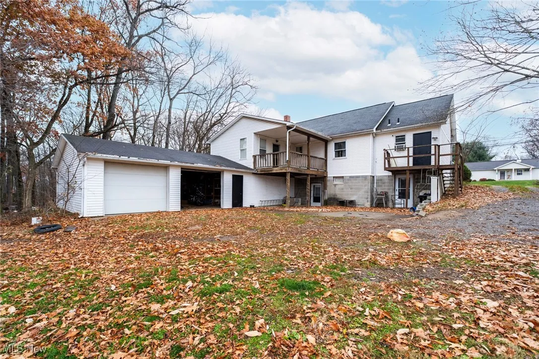 Back of property with an attached garage