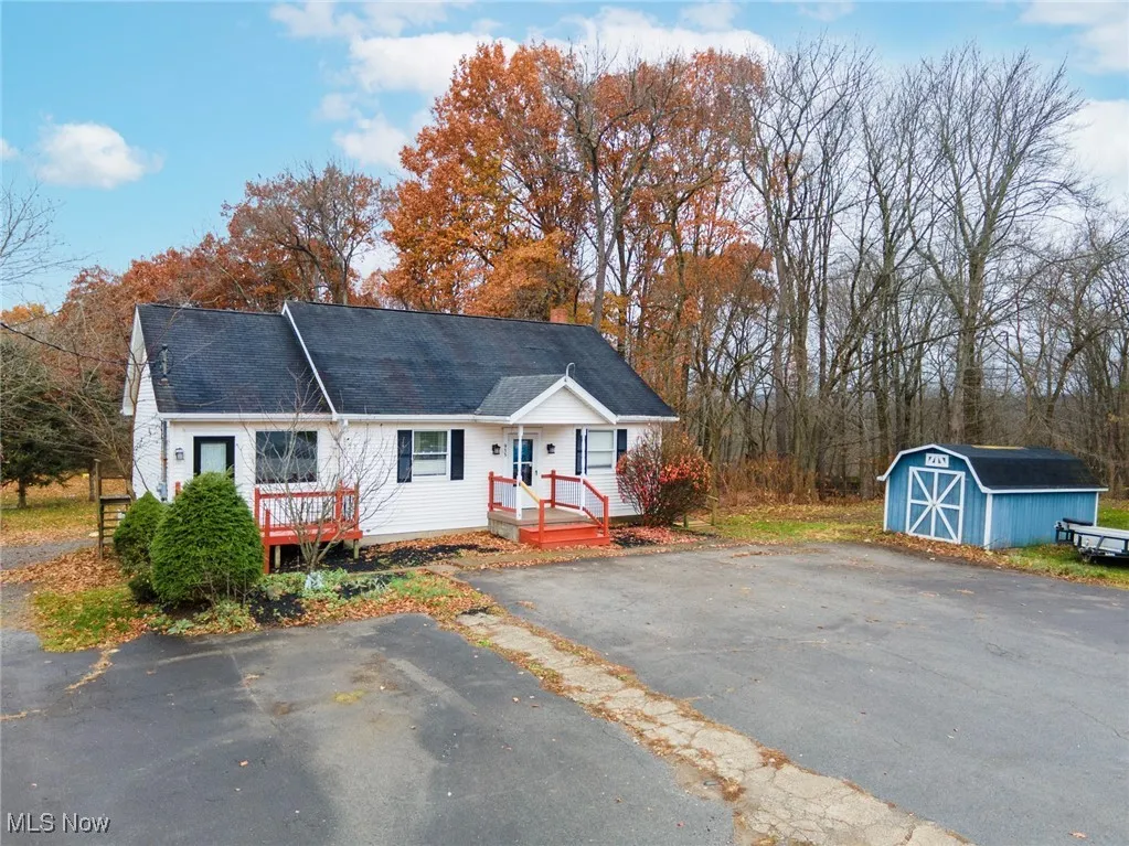 View of front of house with a storage unit