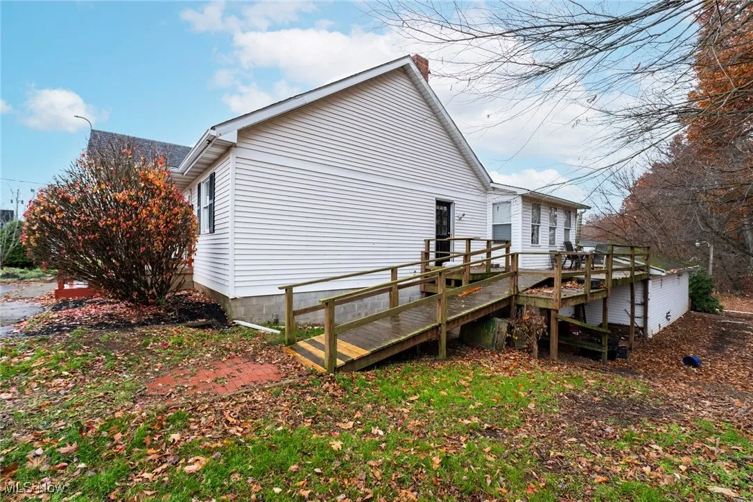 View of home's exterior with a wooden deck and a chimney
