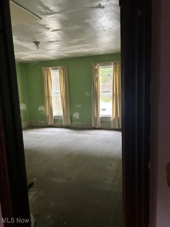 Unfurnished room featuring baseboards