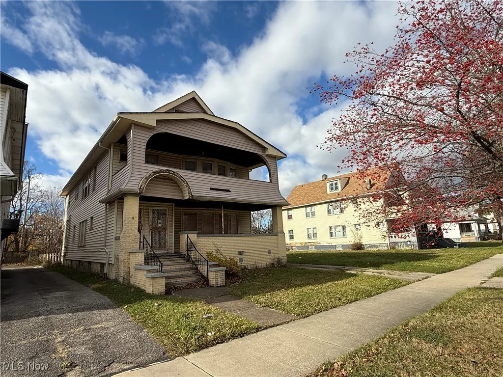View of front of home with a balcony, a front lawn, and crawl space