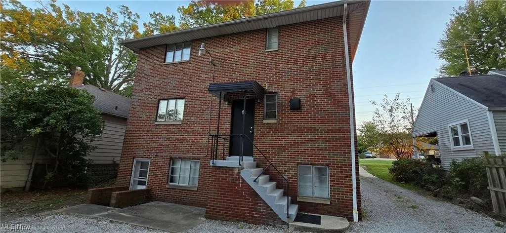 View of back entrance with brick siding