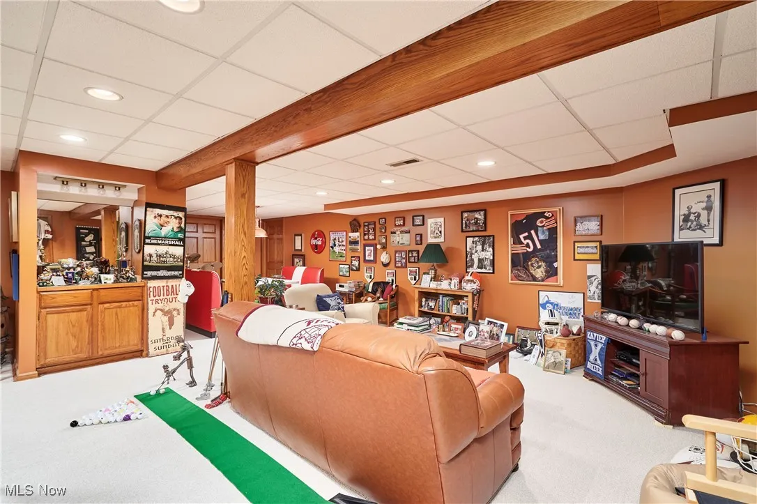Carpeted living area with recessed lighting and a drop ceiling