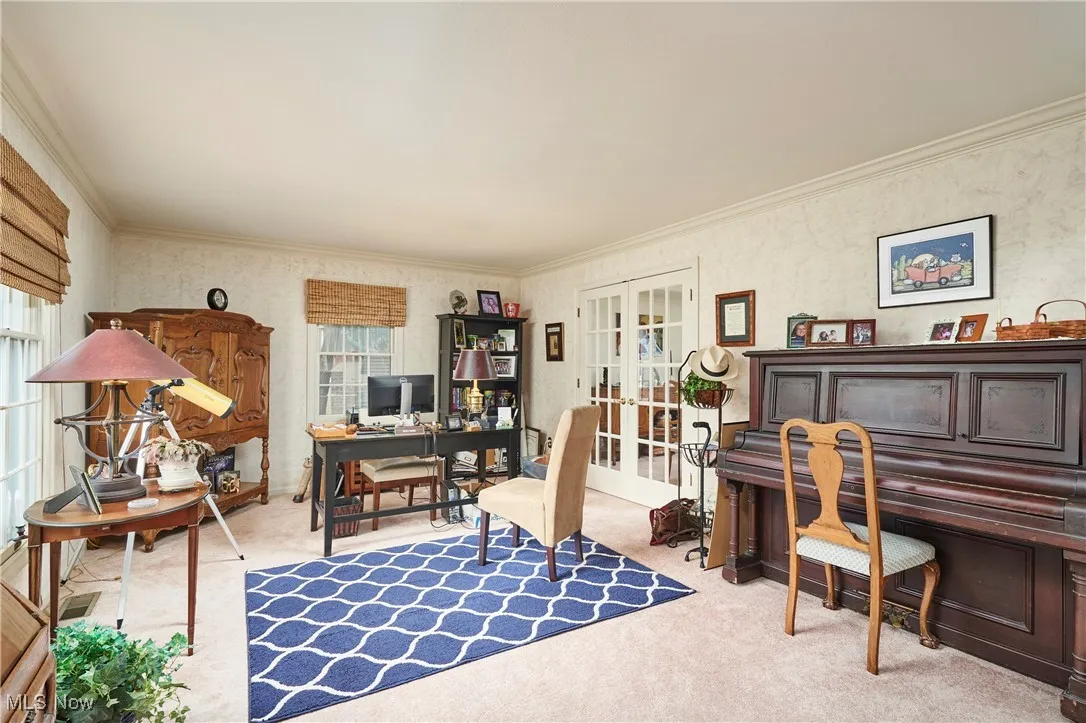 Office featuring french doors, crown molding, and carpet floors