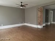 Empty room featuring baseboards and ceiling fan
