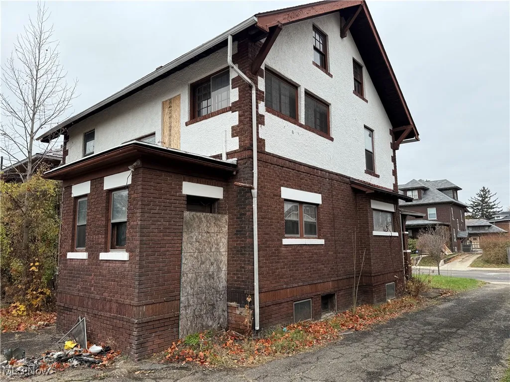 View of side of property with brick siding and stucco siding