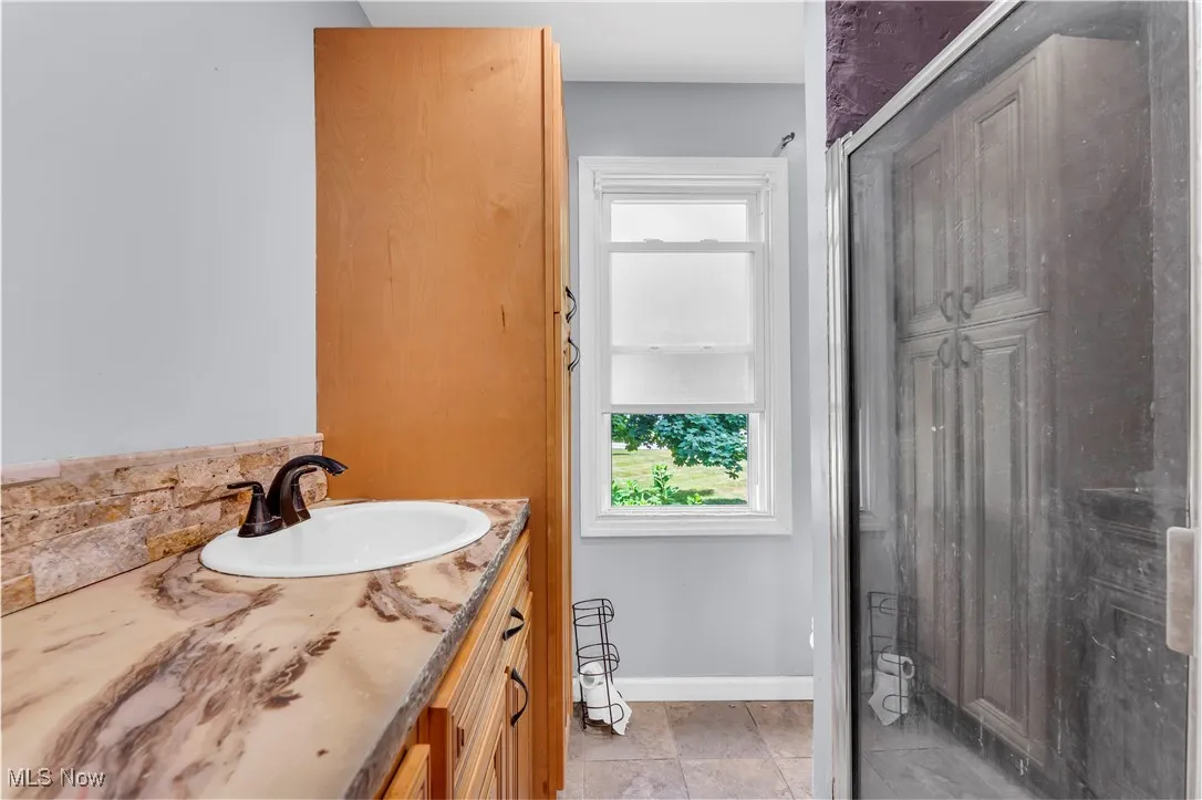 Primary Bathroom with plenty of storage, stand up shower + tub