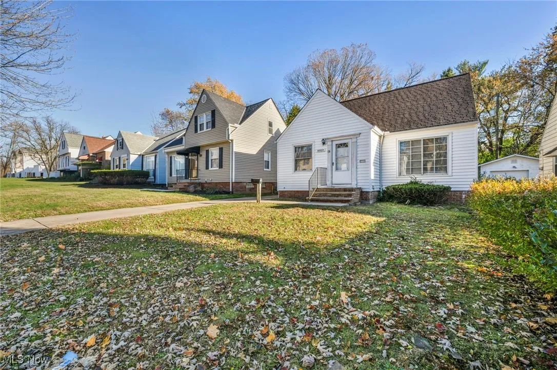 Bungalow featuring a front yard and entry steps