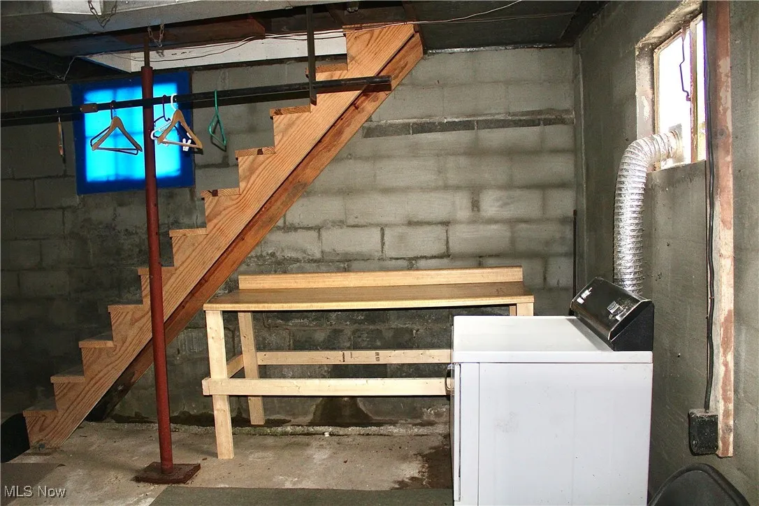 Basement featuring stairway, washer / clothes dryer, and plenty of natural light