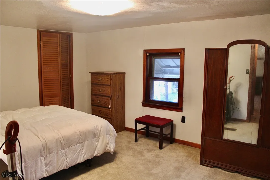 Bedroom with carpet and baseboards