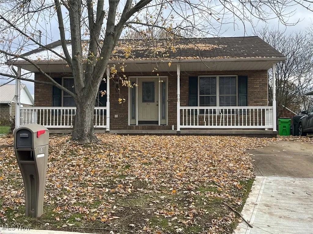View of front of house with covered porch and brick siding