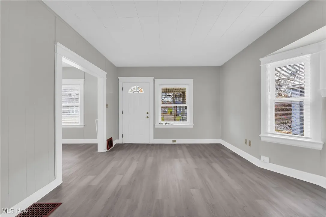 Foyer entrance featuring light wood-style flooring and baseboards