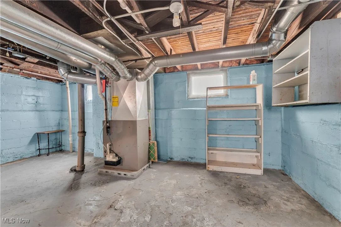 Basement featuring heating unit