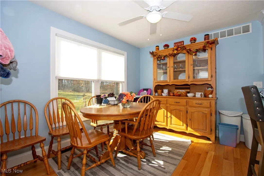 Dining area featuring light wood finished floors and ceiling fan