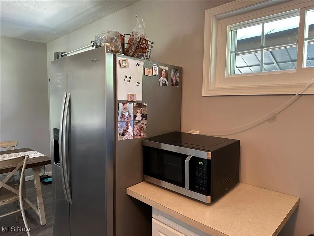 Kitchen with appliances with stainless steel finishes and wood finished floors