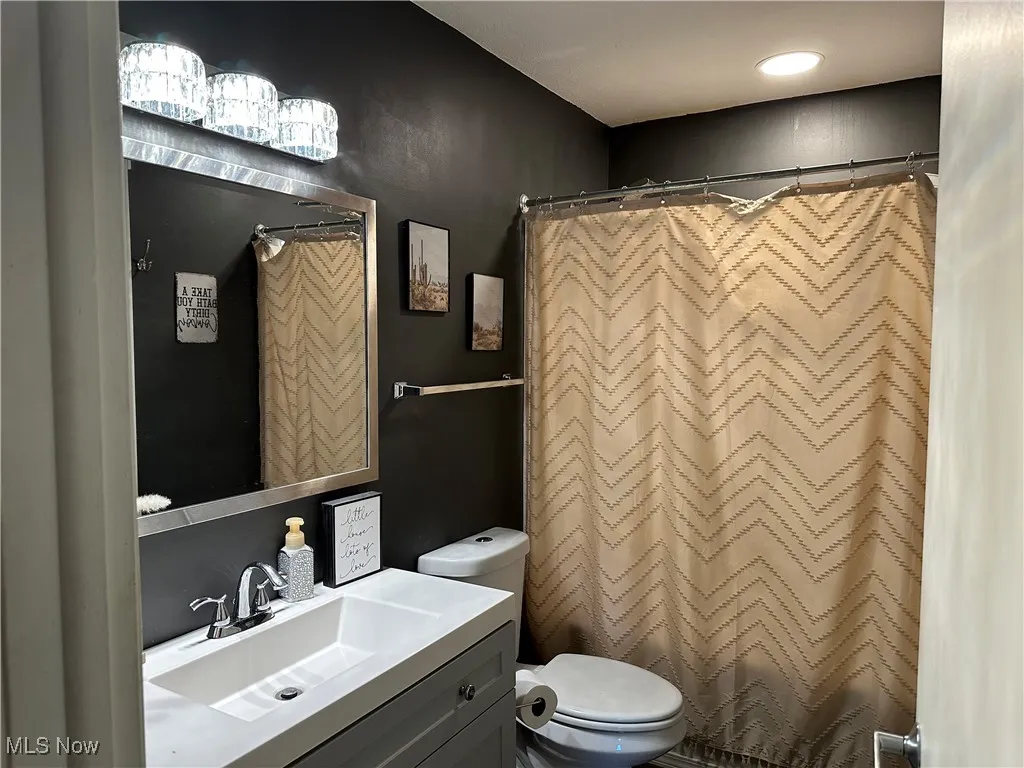 Bathroom featuring vanity and a shower with shower curtain