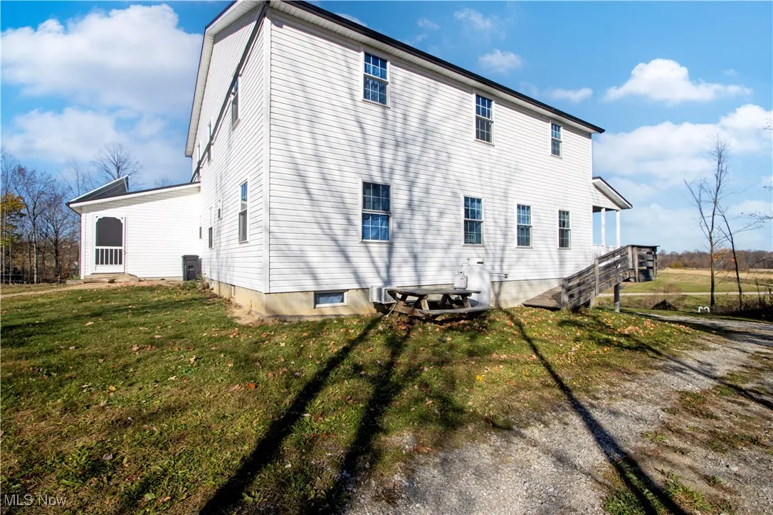 Rear view of house with a lawn