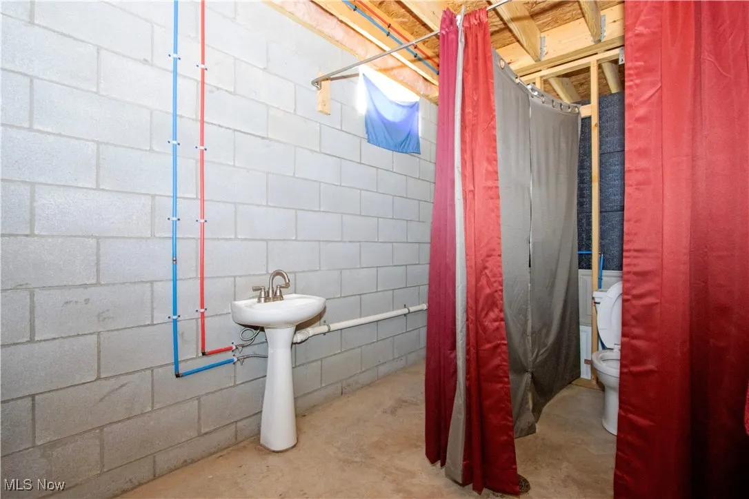Full bathroom featuring toilet and unfinished concrete​​‌​​​​‌​​‌‌​‌‌​​​‌‌​‌​‌​‌​​​‌​​ flooring