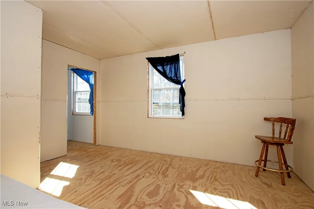 Unfurnished room featuring plenty of natural light