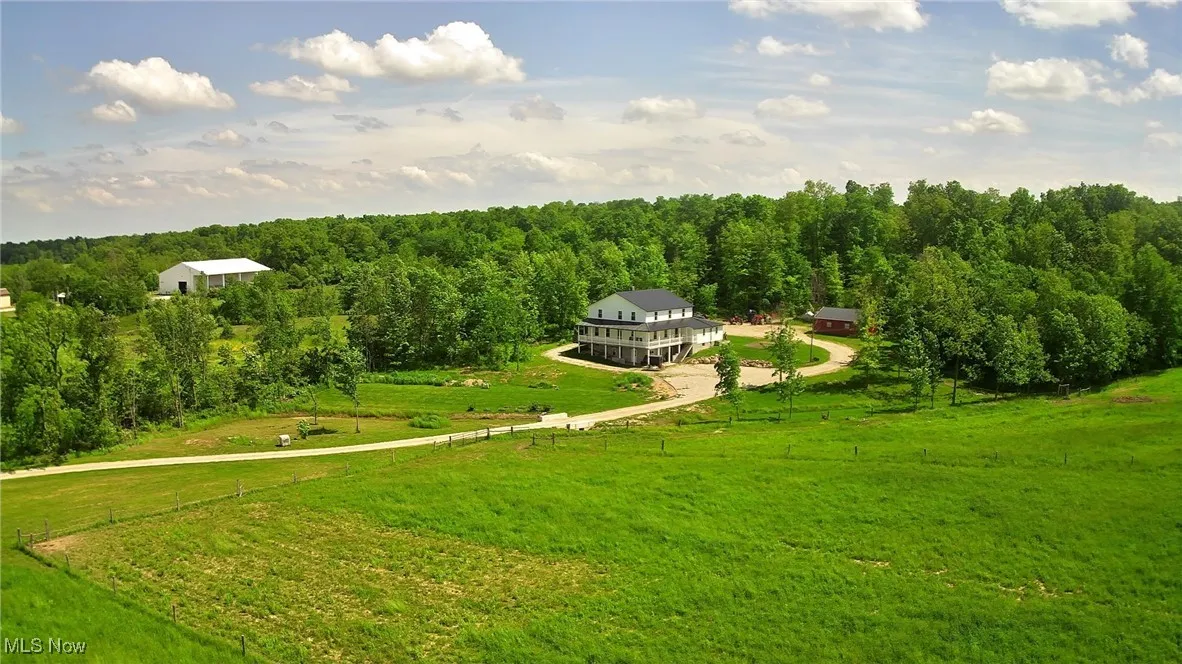 View of home's community with a view of rural / pastoral area, a yard, and a view of trees