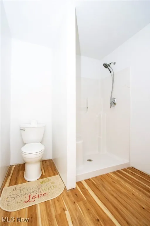 Bathroom with a stall shower and light wood-type flooring