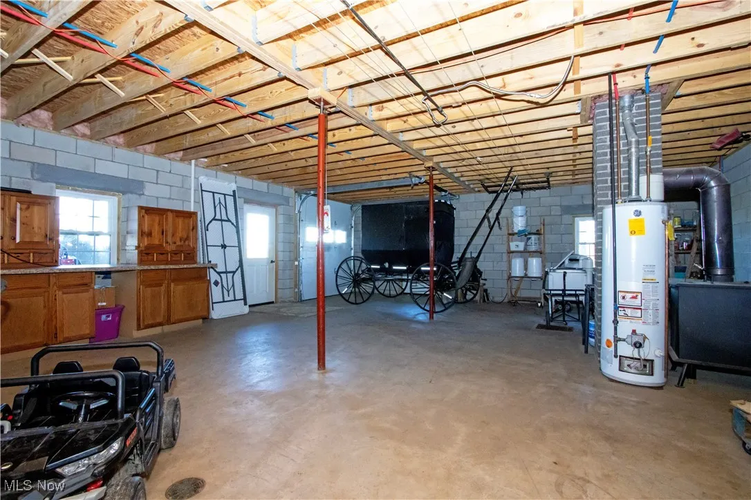 Basement with water heater and concrete block wall
