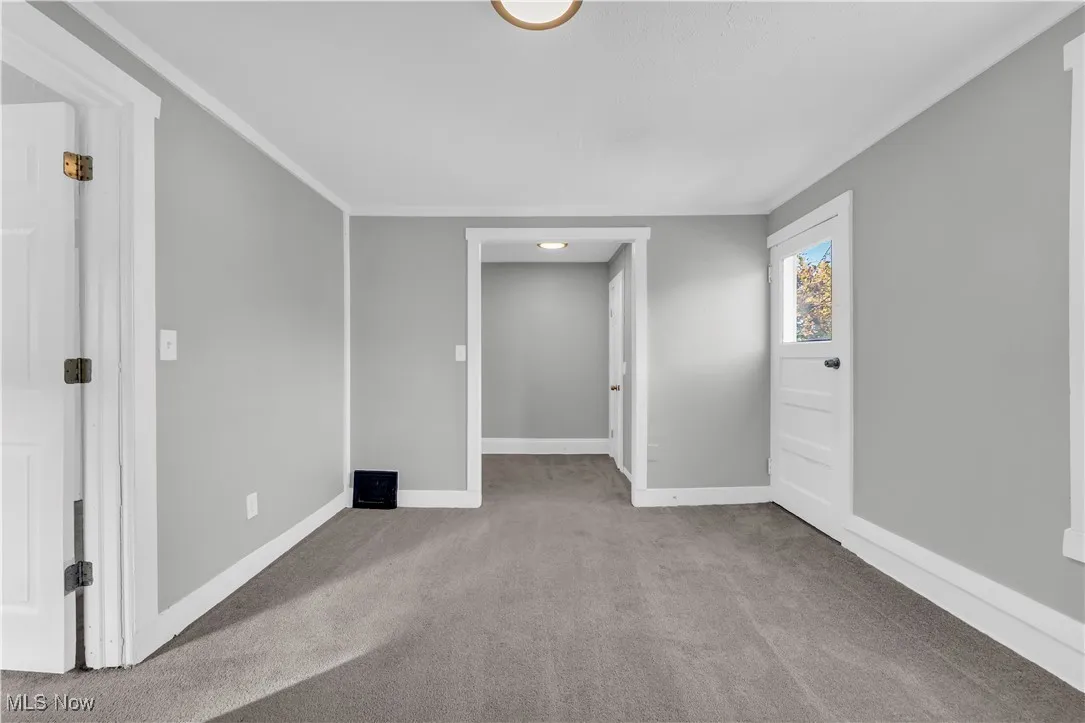 Carpeted spare room with baseboards