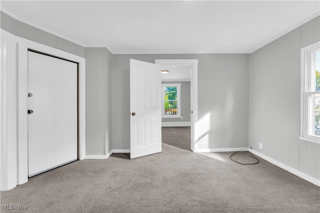 Unfurnished bedroom featuring carpet floors and baseboards