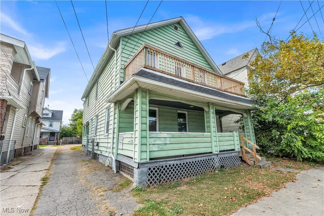 View of front of home featuring a porch, asphalt driveway, and crawl space