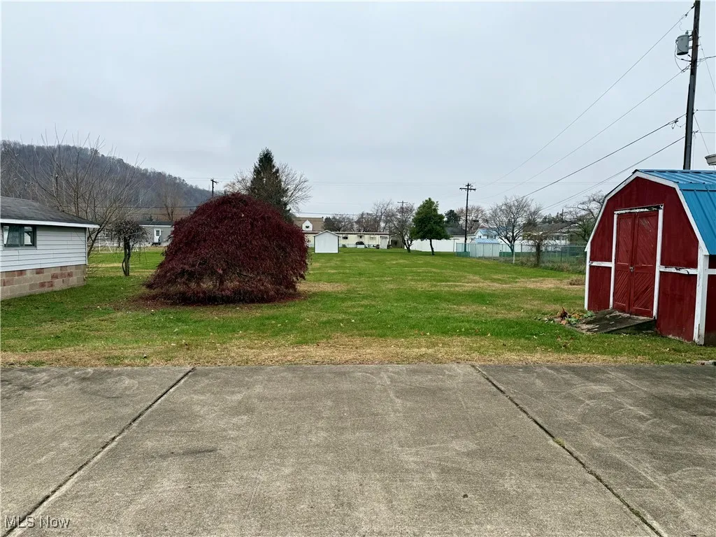 View of yard featuring a storage shed and a mountain view
