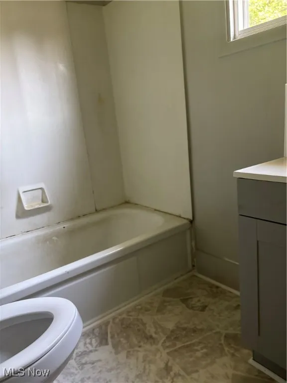 Bathroom featuring vanity and a tub to relax in