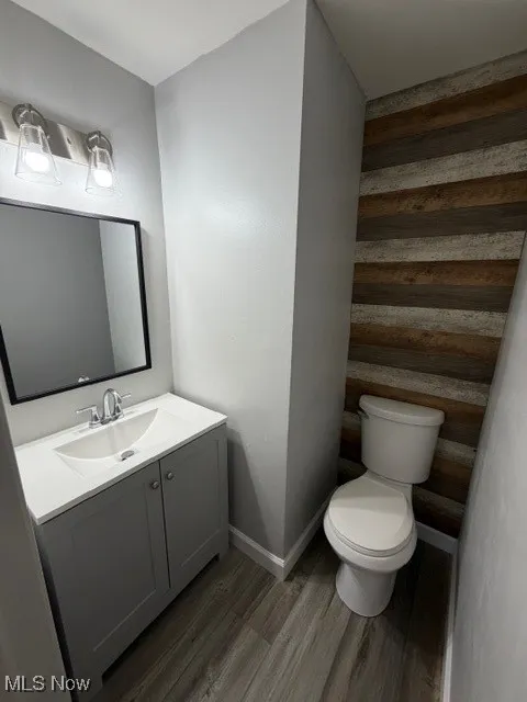 Half bath featuring vanity and light wood-style flooring