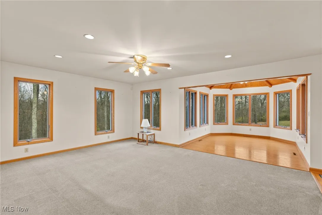 Empty room featuring light colored carpet and recessed lighting