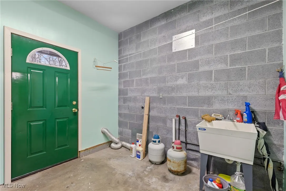 Foyer with concrete block wall and concrete floors