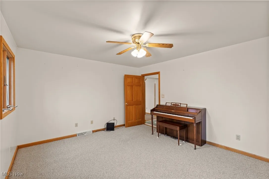 Miscellaneous room featuring carpet floors and a ceiling fan