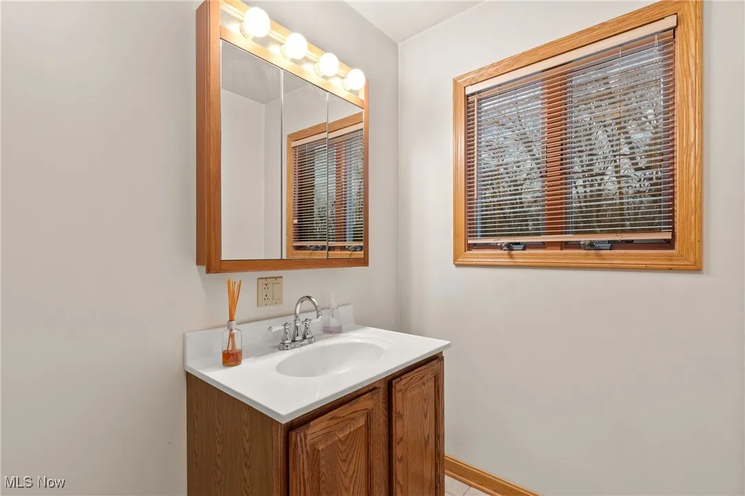 Bathroom featuring vanity and baseboards