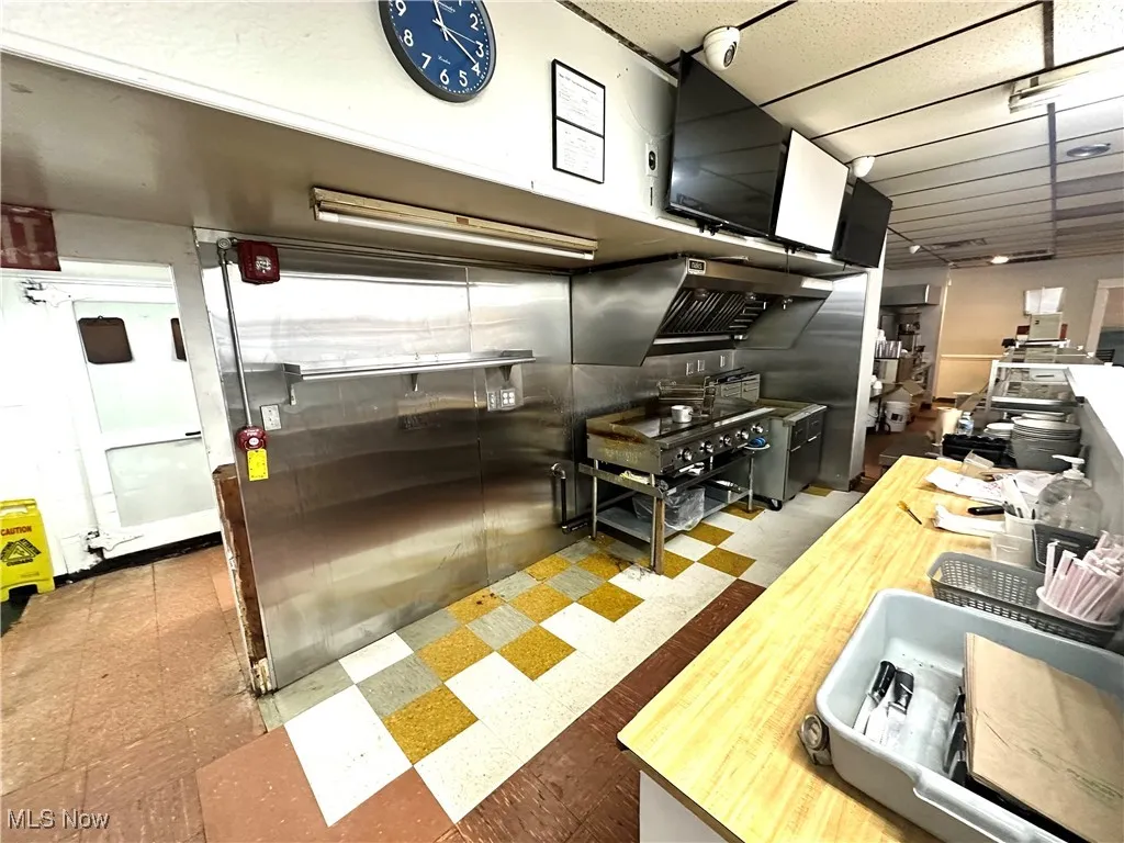 Kitchen featuring a paneled ceiling and wood counters