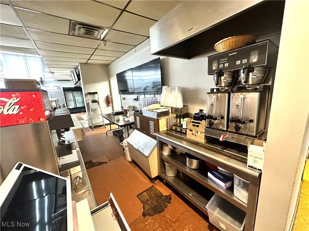 Kitchen with a paneled ceiling and exhaust hood